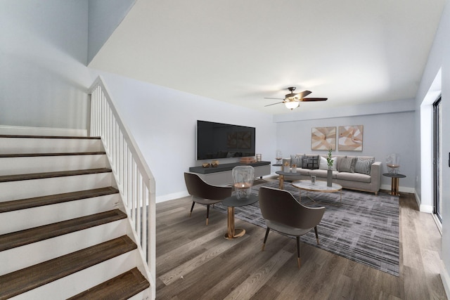 living room with wood-type flooring and ceiling fan