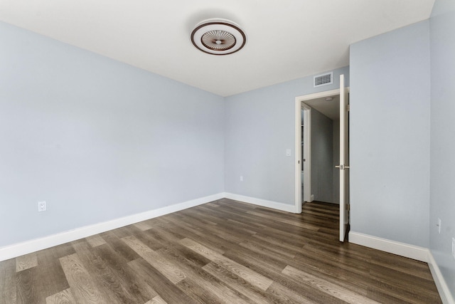 unfurnished bedroom with dark hardwood / wood-style flooring