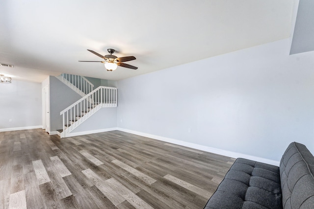 unfurnished living room featuring wood-type flooring and ceiling fan