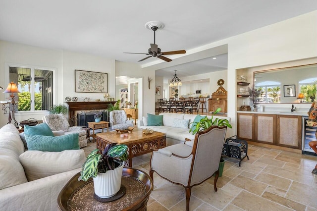 living room featuring ceiling fan, plenty of natural light, and wine cooler