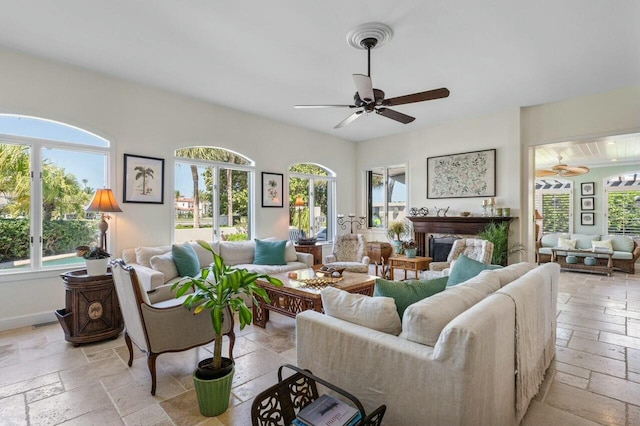 living room with ceiling fan and plenty of natural light