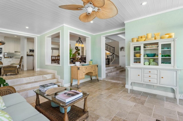 living room featuring ceiling fan with notable chandelier, crown molding, and wooden ceiling