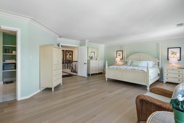 bedroom featuring light hardwood / wood-style floors and crown molding