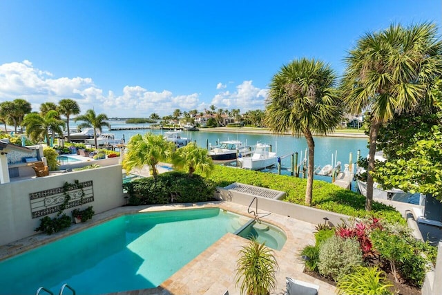 view of swimming pool featuring a water view