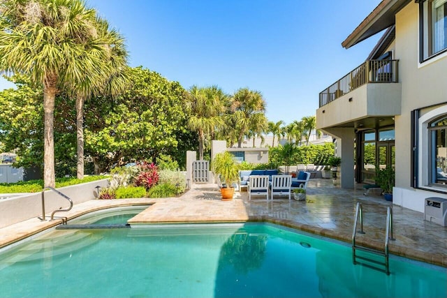 view of swimming pool with outdoor lounge area and a patio area