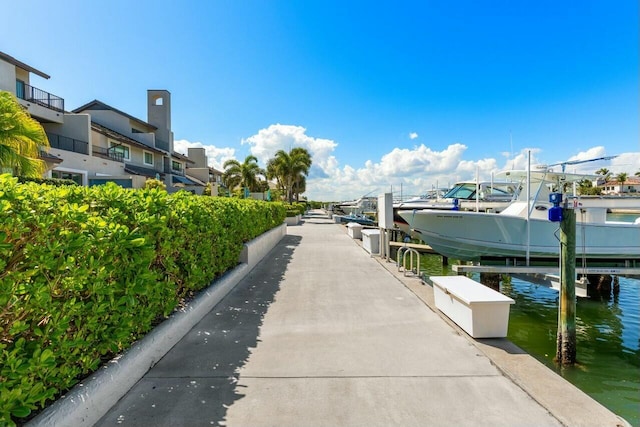 view of community featuring a water view and a boat dock