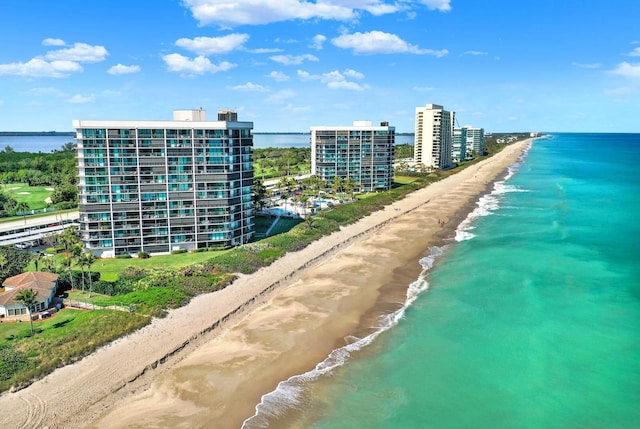 drone / aerial view with a water view and a view of the beach