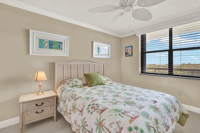 carpeted bedroom with ornamental molding, ceiling fan, and a textured ceiling