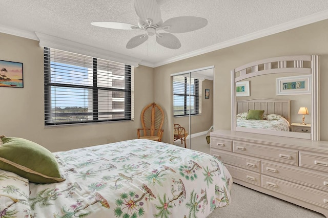 carpeted bedroom featuring ornamental molding and a textured ceiling