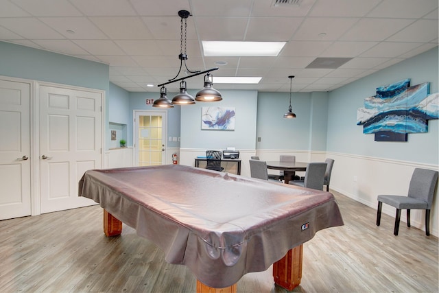 rec room with a paneled ceiling, billiards, and light wood-type flooring