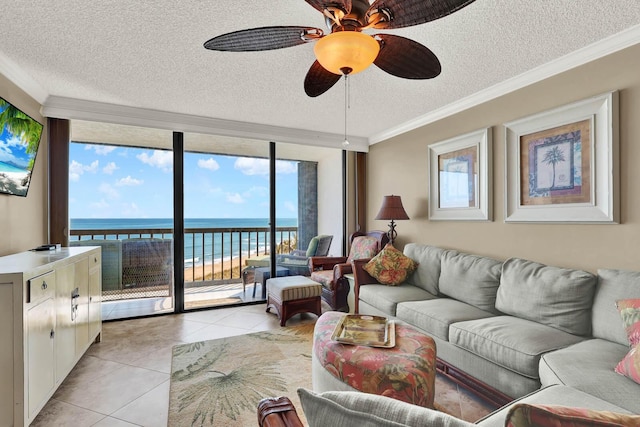 tiled living room featuring a water view, crown molding, a textured ceiling, expansive windows, and ceiling fan