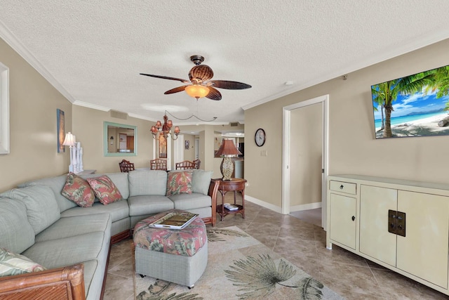 living room with ceiling fan, ornamental molding, a textured ceiling, and light tile patterned floors