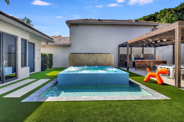 exterior space featuring exterior bar, a lawn, a pergola, stucco siding, and a hot tub