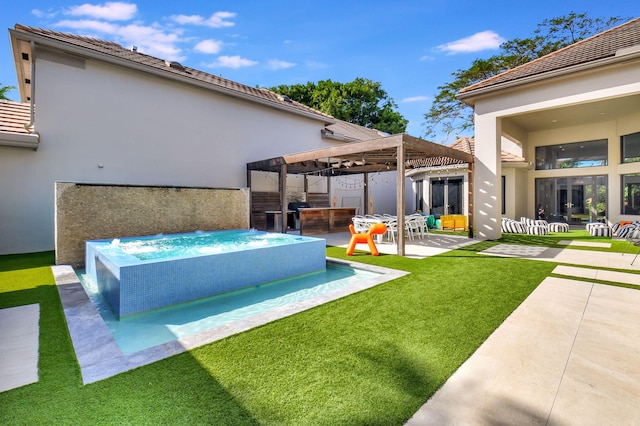 exterior space with a yard, a patio area, a jacuzzi, and a pergola