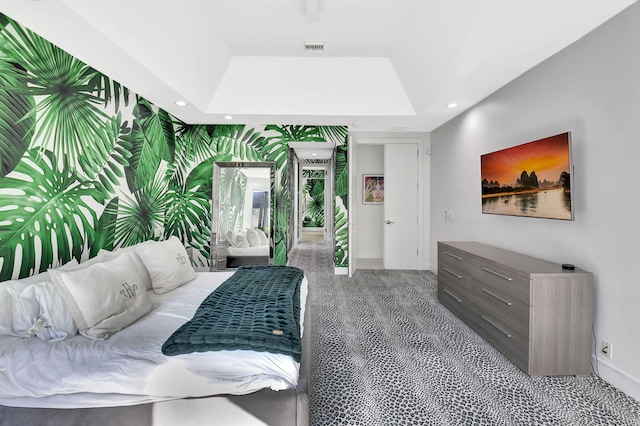 bedroom featuring a tray ceiling, recessed lighting, visible vents, an accent wall, and wallpapered walls