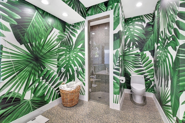 bathroom with baseboards, a stall shower, toilet, and recessed lighting