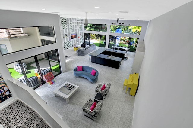 living area featuring baseboards, visible vents, and recessed lighting