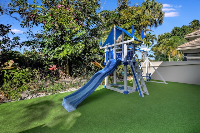 view of play area featuring a yard and fence