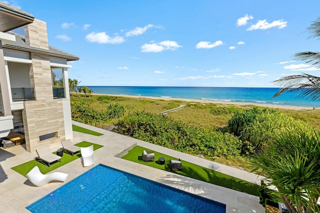 exterior space featuring a water view, a view of the beach, and a patio