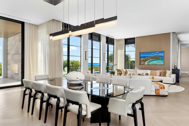 dining space with floor to ceiling windows and light parquet flooring