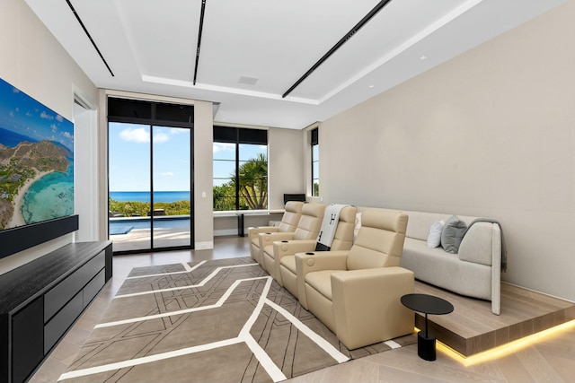 living room with a tray ceiling and a water view