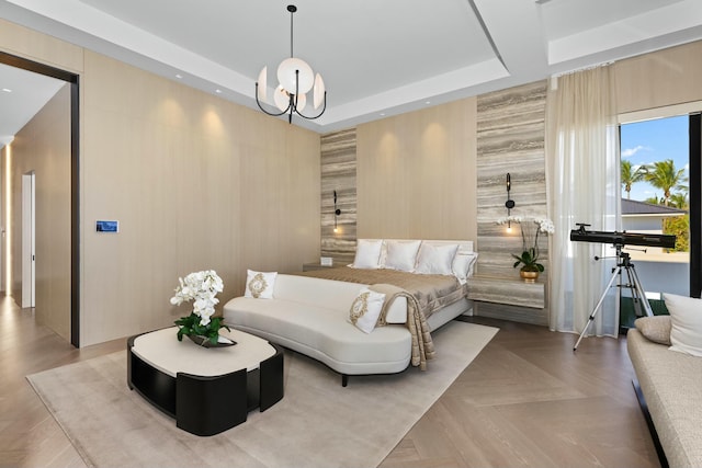 bedroom with light parquet floors, a notable chandelier, and a tray ceiling