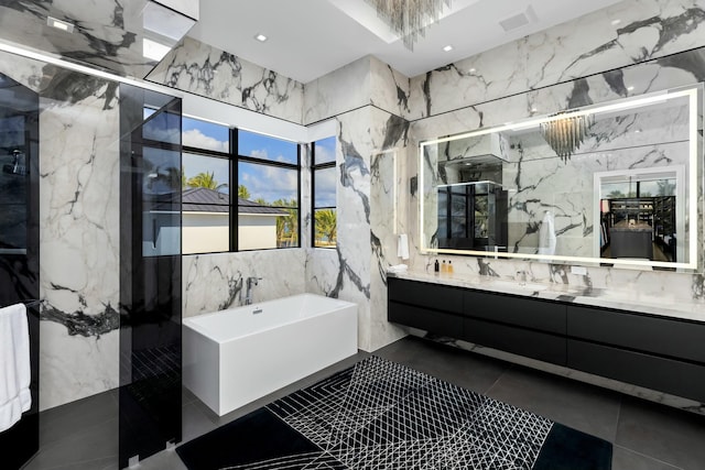 bathroom with tile patterned flooring, vanity, and separate shower and tub