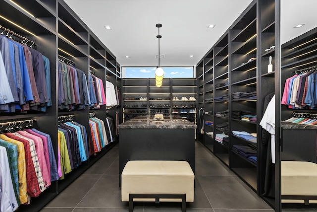 spacious closet with dark tile patterned floors