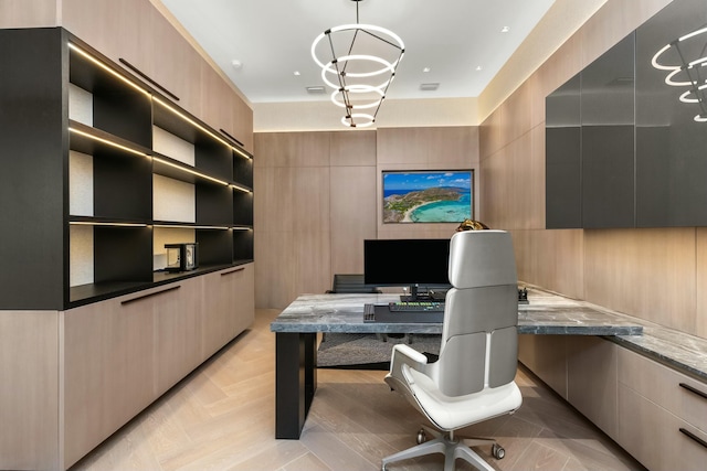 office featuring light parquet flooring, tile walls, and a chandelier