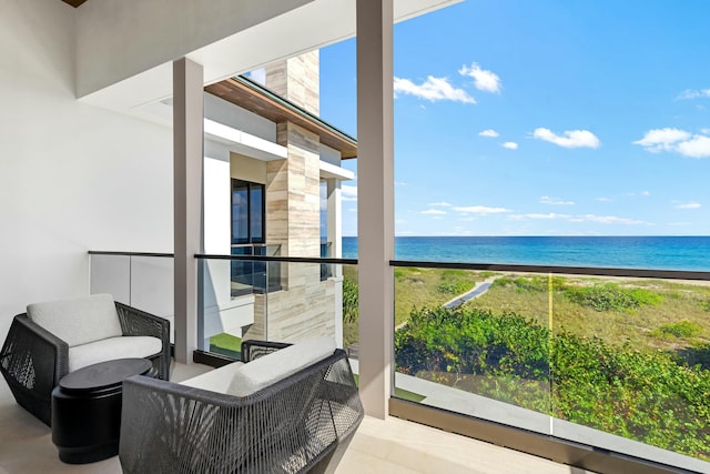 balcony with a water view and a beach view