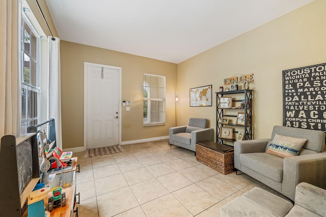 living area with light tile patterned floors and baseboards