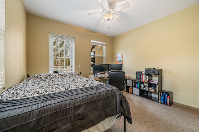 bedroom with a ceiling fan, carpet flooring, and baseboards