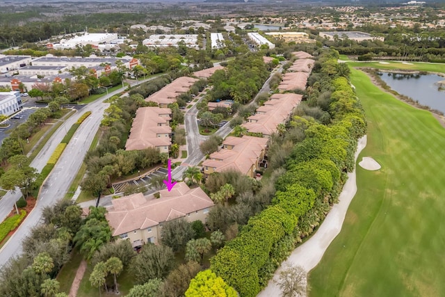 birds eye view of property with view of golf course, a water view, and a residential view