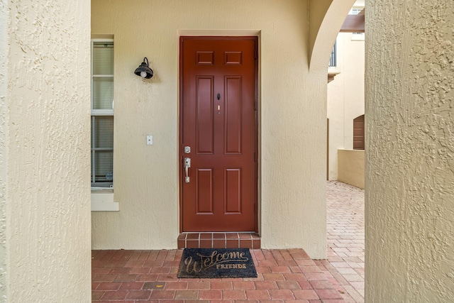 property entrance with stucco siding