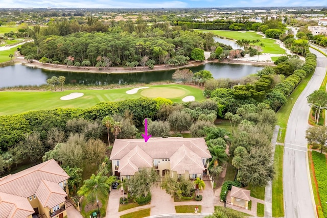 birds eye view of property with a water view and golf course view