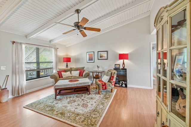 living room with vaulted ceiling with beams, light wood finished floors, baseboards, and a ceiling fan