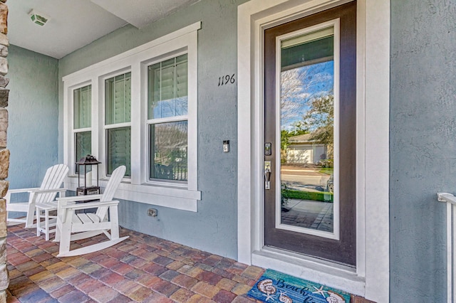 view of exterior entry with a porch