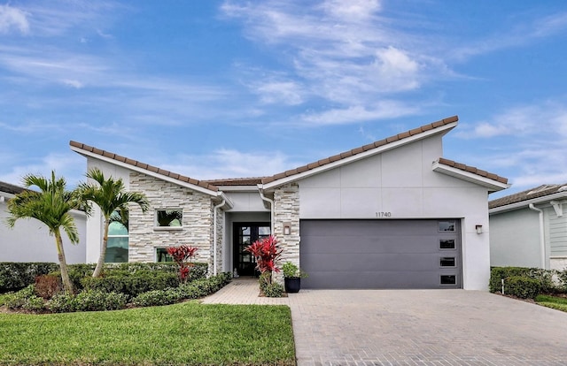 view of front facade with a garage and a front lawn