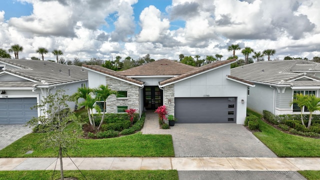 view of front of house with a garage and a front yard