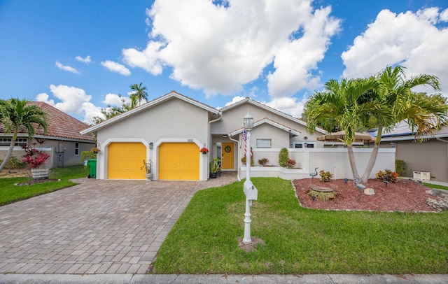 view of front of property with a garage and a front lawn