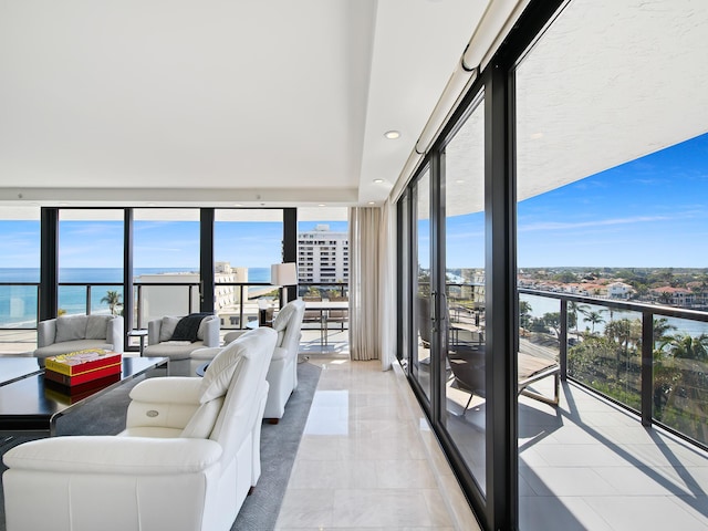 tiled living room with a water view and expansive windows