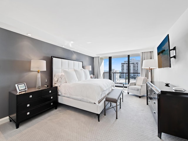 carpeted bedroom featuring floor to ceiling windows