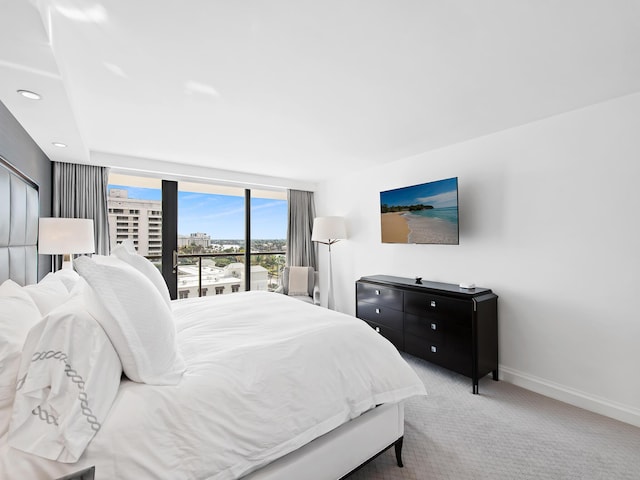 carpeted bedroom featuring access to outside and expansive windows