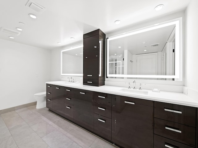 bathroom with toilet, vanity, tile patterned flooring, and a shower with door