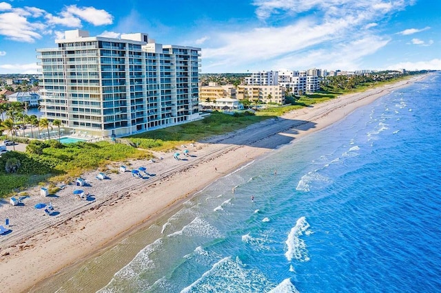 drone / aerial view with a water view and a beach view