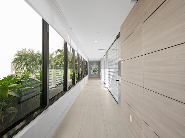 hall featuring light tile patterned floors