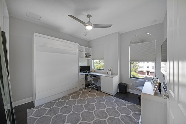 home office featuring a ceiling fan, baseboards, visible vents, and dark wood-style flooring