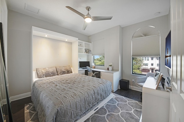 bedroom featuring visible vents, ceiling fan, baseboards, and wood finished floors