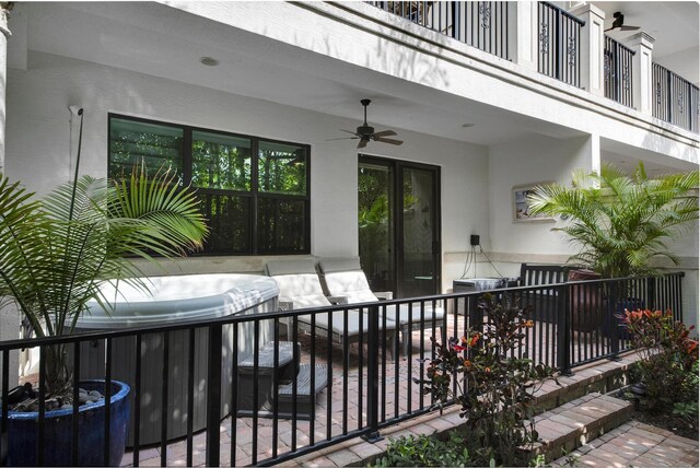 view of community with a patio area and a hot tub