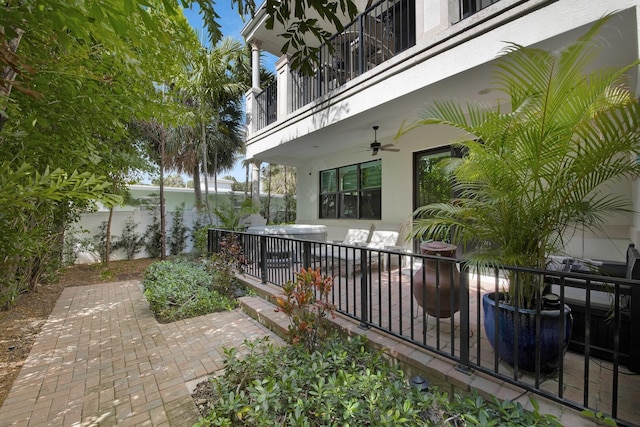 view of patio featuring a balcony, fence, and a ceiling fan